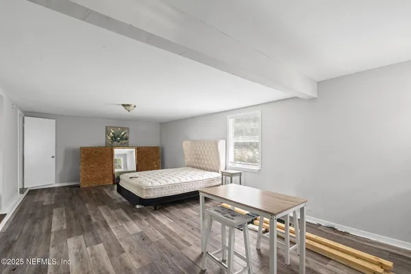 a bedroom with a bed and a table