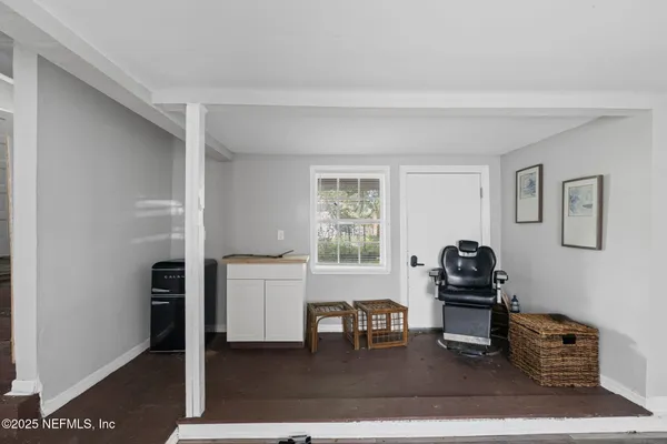 a living room with furniture a dining table and a window