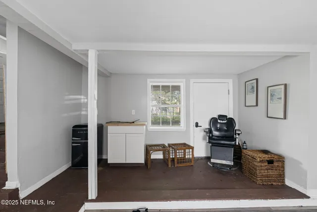 a living room with furniture a dining table and a window
