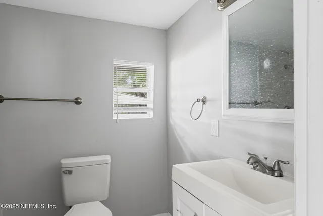 a bathroom with a toilet and a sink