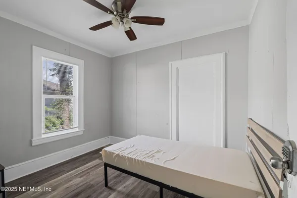 a bedroom with a bed and a window