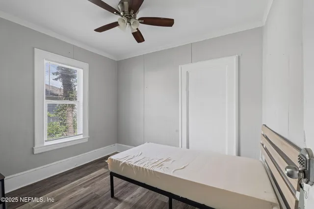 a bedroom with a bed and a window