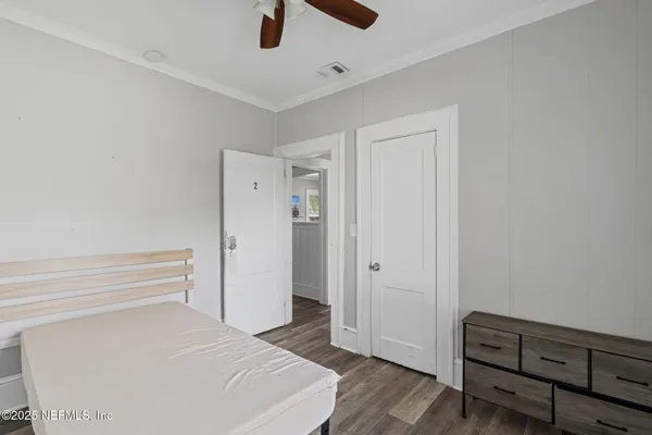 a room with a bed and a view of closet