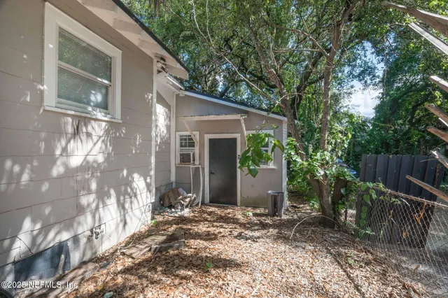 a view of a house with a yard and plants