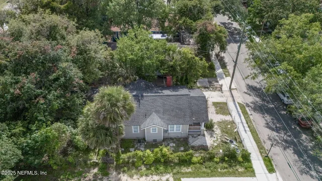 an aerial view of a house with yard and outdoor seating