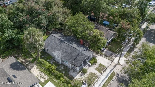 an aerial view of a house with a yard