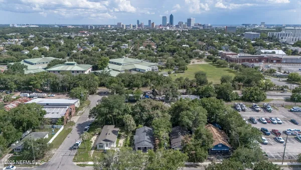 an aerial view of residential houses with city view