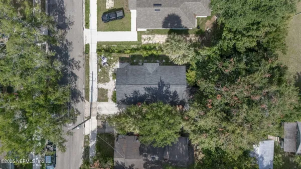 an aerial view of a house with a yard