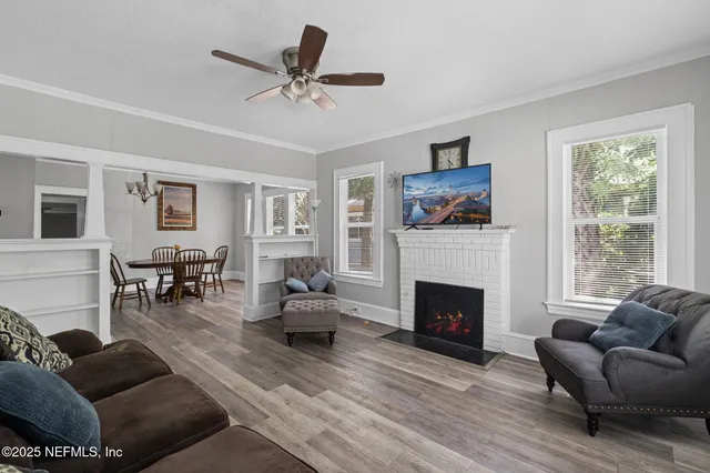 a living room with furniture and fireplace
