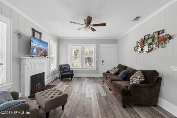 a living room with furniture fireplace and flat screen tv