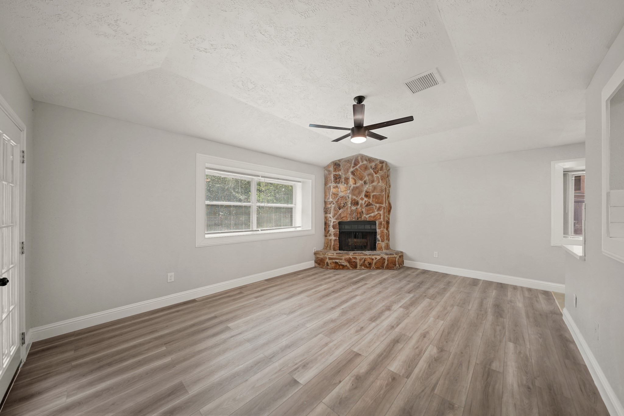 3623 Peachstone Place Spring, TX 77389 - Photo 6 of 20 a view of an empty room with a window and wooden floor