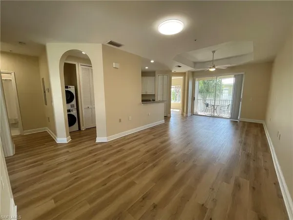 a view of an empty room and glass door