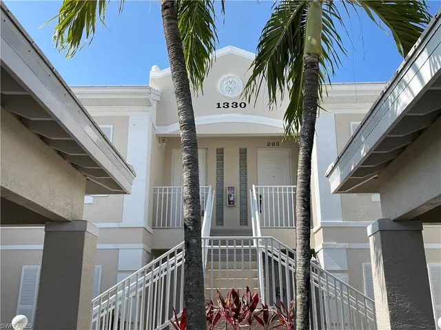 a view of a house with a palm tree