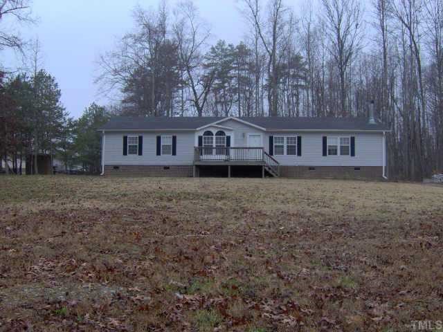 5950 Oxford Road Roxboro, NC 27574 - Photo 1 of 1 front view of house with a yard
