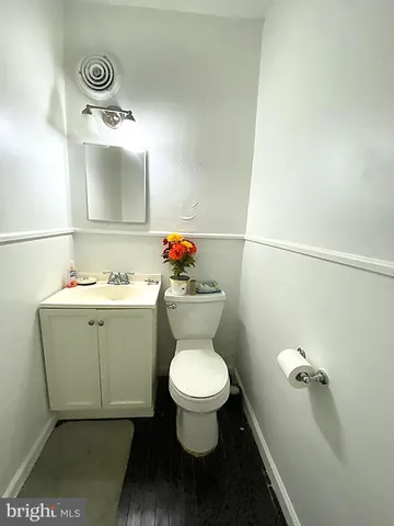 a bathroom with a toilet a sink and mirror