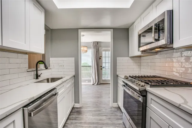 a kitchen that has a sink and a stove