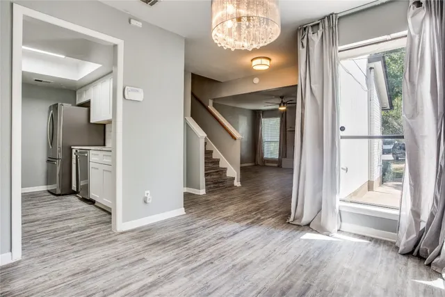 a view of entryway and hall with wooden floor