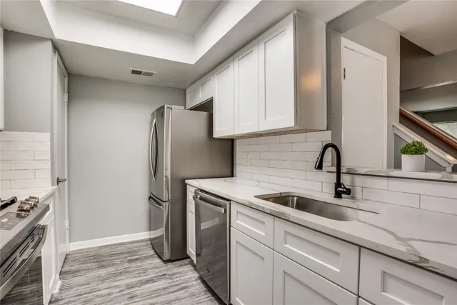 a kitchen with a sink and a refrigerator