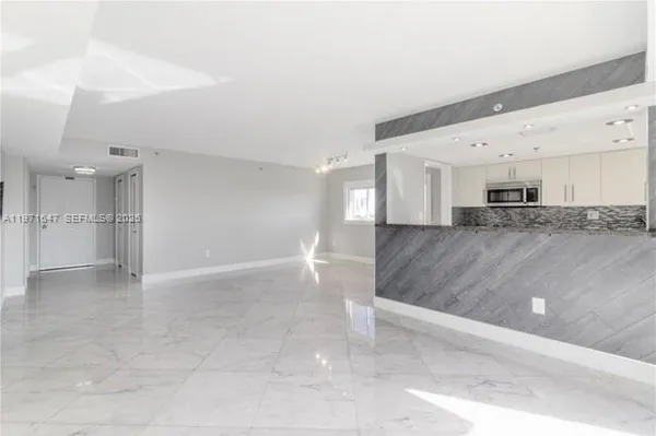 a view of kitchen and kitchen with stainless steel appliances