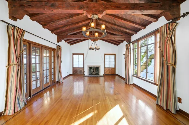 a view of a room with wooden floor and windows