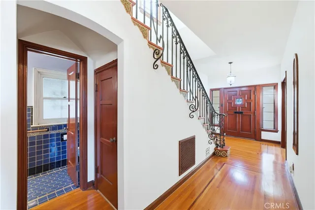a dining room with furniture and a floor to ceiling window