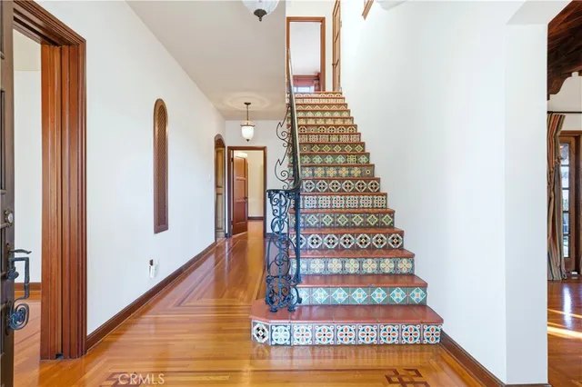 a kitchen with granite countertop cabinets stainless steel appliances and wooden floor