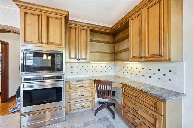 a stove top oven sitting inside of a kitchen
