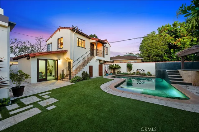 a view of a patio with a table and chairs under an umbrella