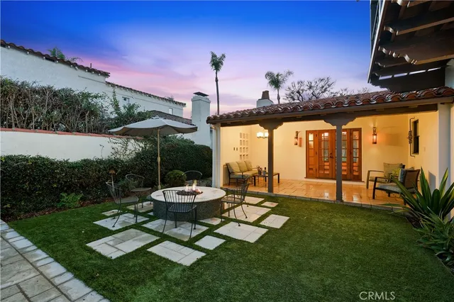 a backyard of a house with table and chairs