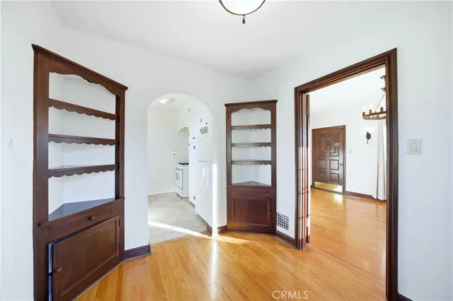 a front view of a house with plants and trees