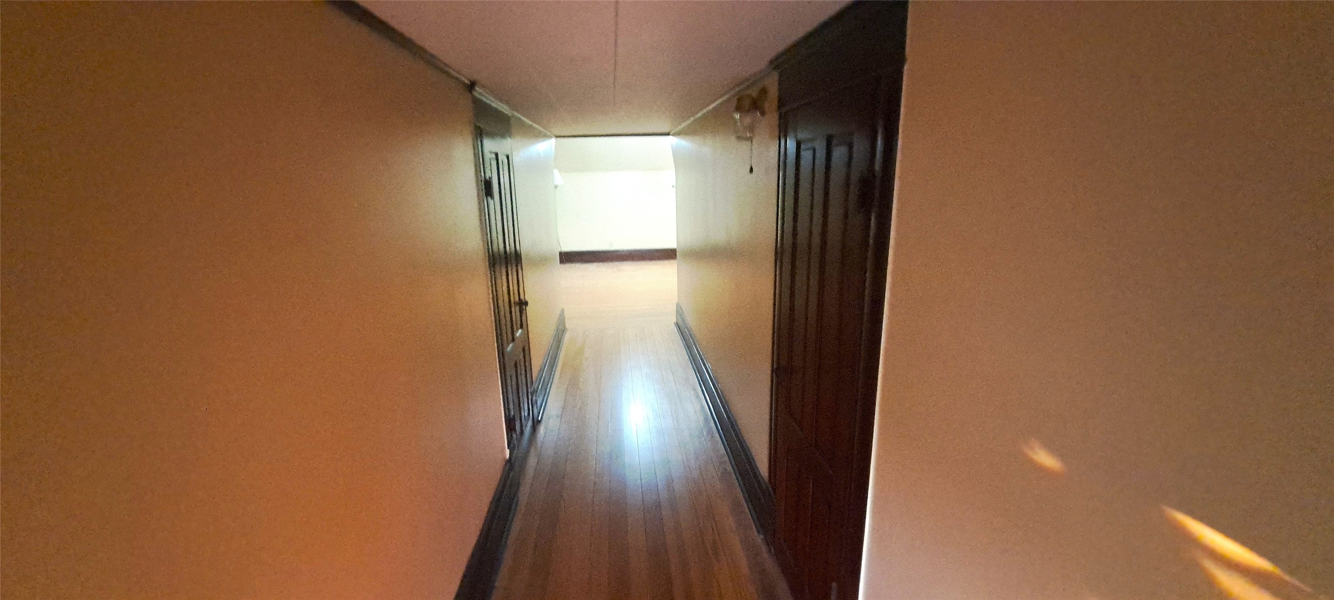 105 Davis Drive Thorndale, TX 76577 - Photo 13 of 21 Gleaming hardwood flooring leads down a long hallway lined with classic wood doors.