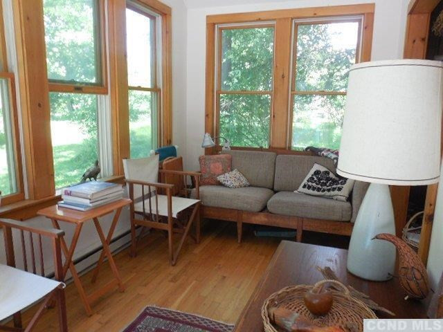 277 Birch Hill Road Copake, NY 12521 - Photo 8 of 19 a living room with furniture and a large window