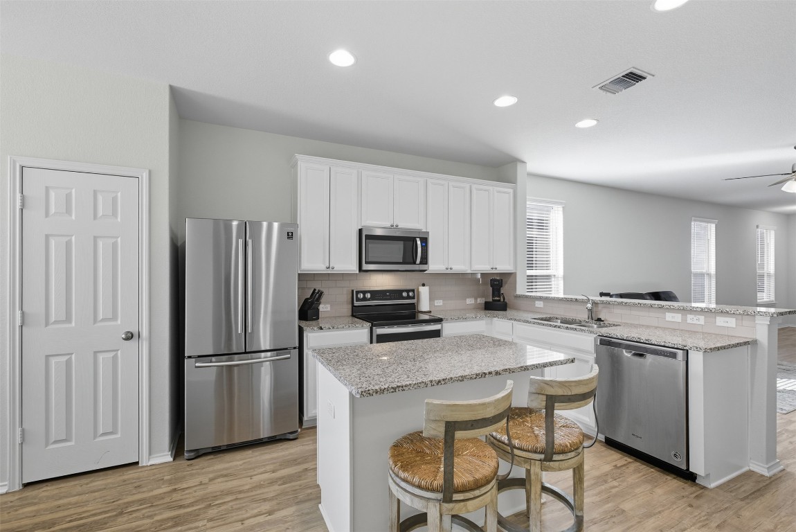 a kitchen with a stove a sink and a refrigerator