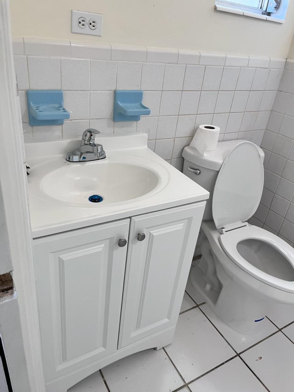 2213 2nd Street Southwest Vero Beach, FL 32962 - Photo 17 of 18 a bathroom with a toilet sink and mirror