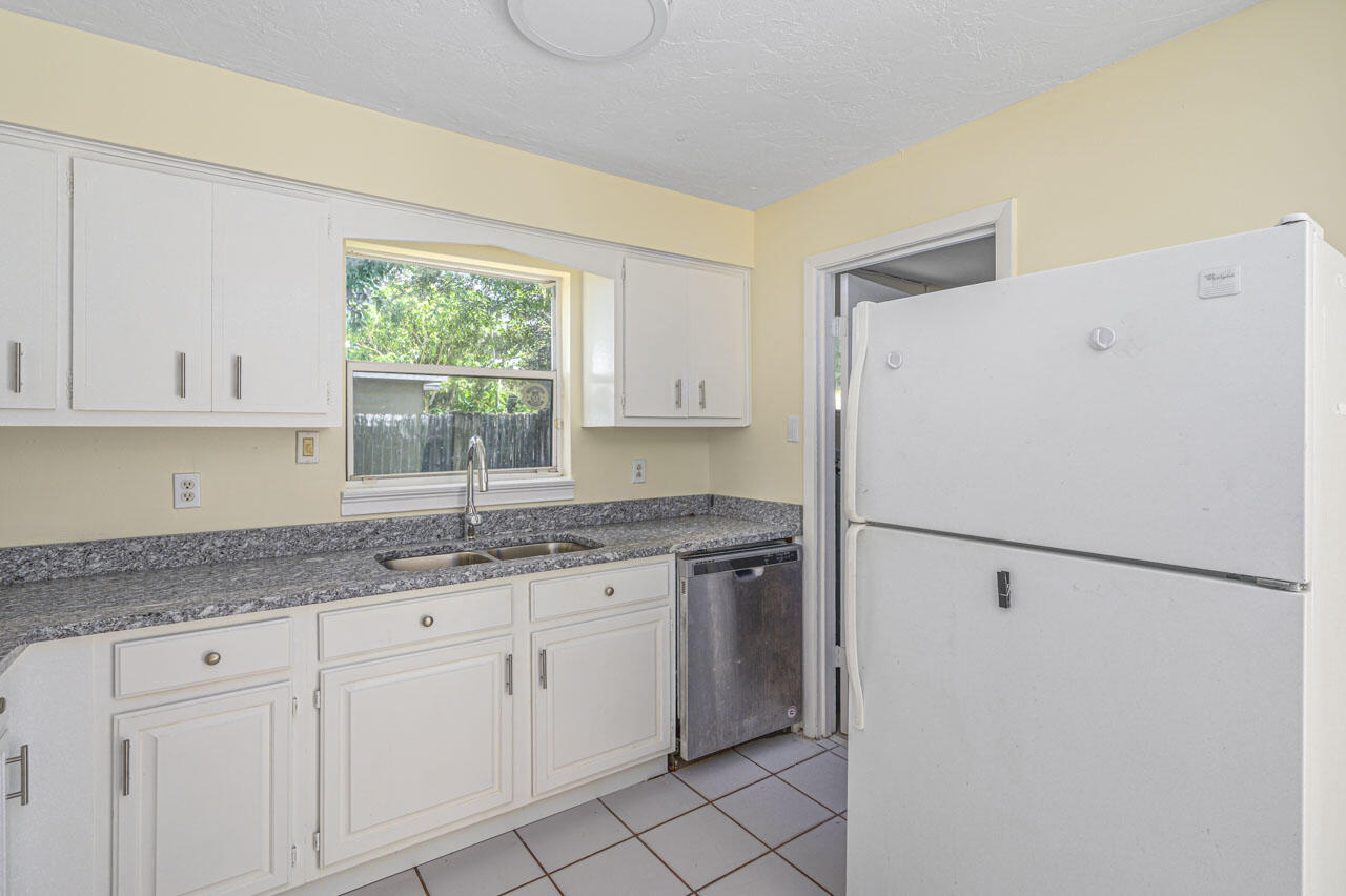 2213 2nd Street Southwest Vero Beach, FL 32962 - Photo 9 of 18 a kitchen with a sink a refrigerator and window