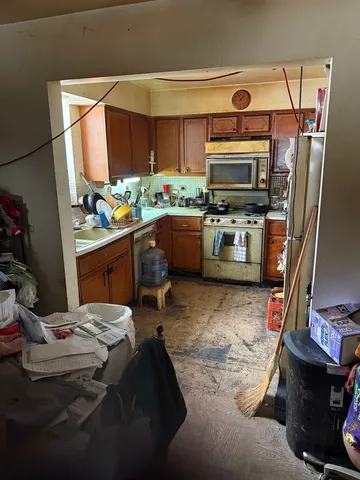 a kitchen with a sink appliances and cabinets