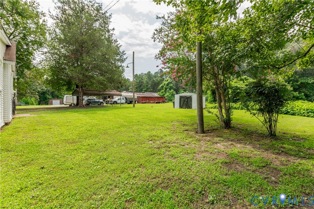 661 CCC Road Crewe, VA 23930 - Photo 29 of 38 Expansive green lawn with mature trees and a detac