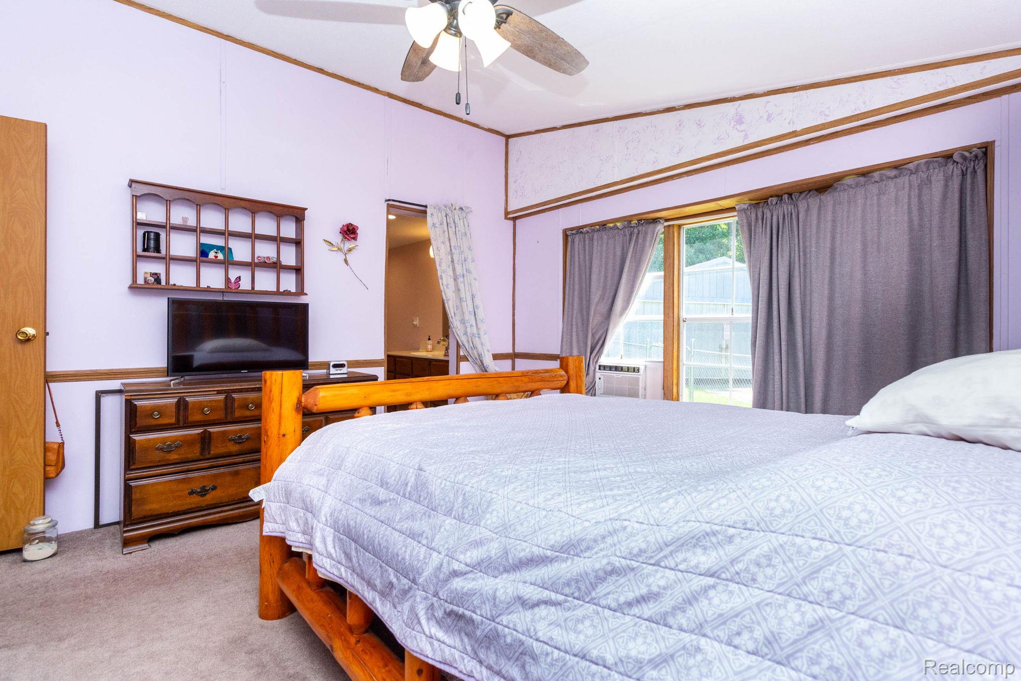 38 South Force Road Attica, MI 48412 - Photo 18 of 53 Bedroom featuring light purple walls, wood trim accents, and carpet flooring