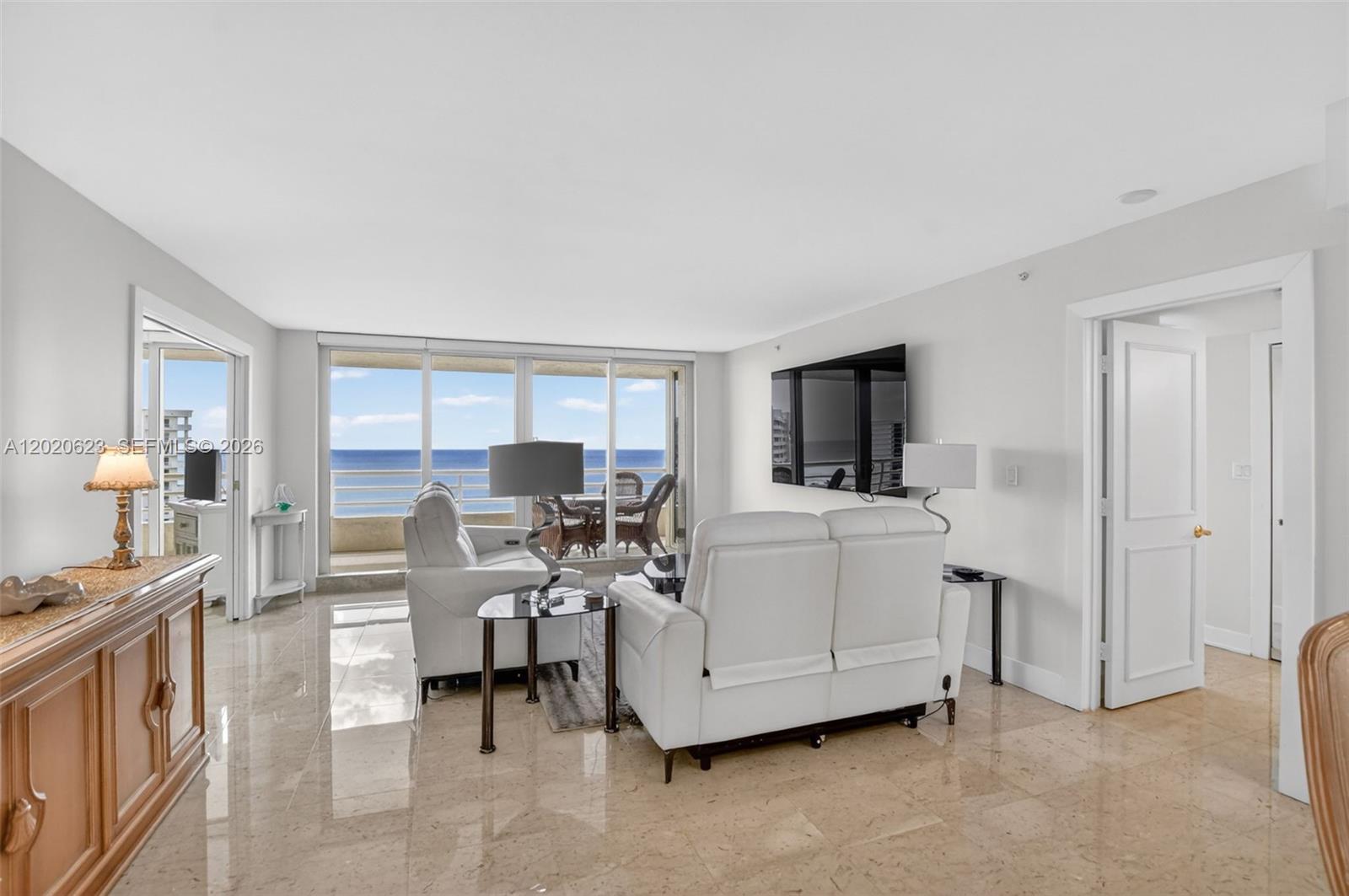 4101 North Ocean Boulevard, Unit 1605 Boca Raton, FL 33431 - Photo 12 of 35 a living room with furniture and a flat screen tv