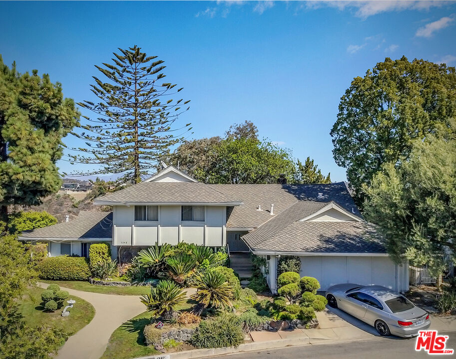 1342 Stradella Road Los Angeles, CA 90077 - Photo 1 of 24 a front view of a house with a yard