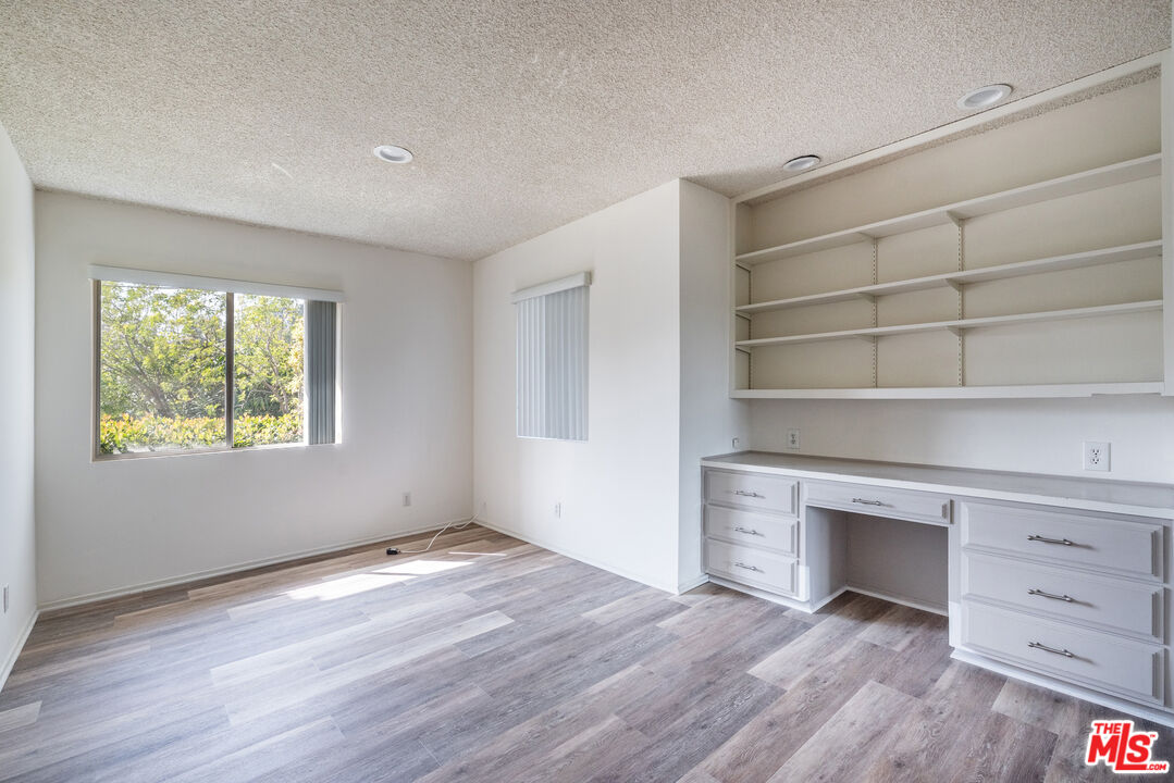 1342 Stradella Road Los Angeles, CA 90077 - Photo 11 of 24 wooden floor in an empty room with a window