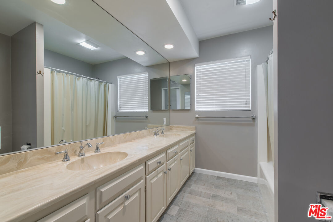 1342 Stradella Road Los Angeles, CA 90077 - Photo 13 of 24 a bathroom with a double vanity sink and mirror