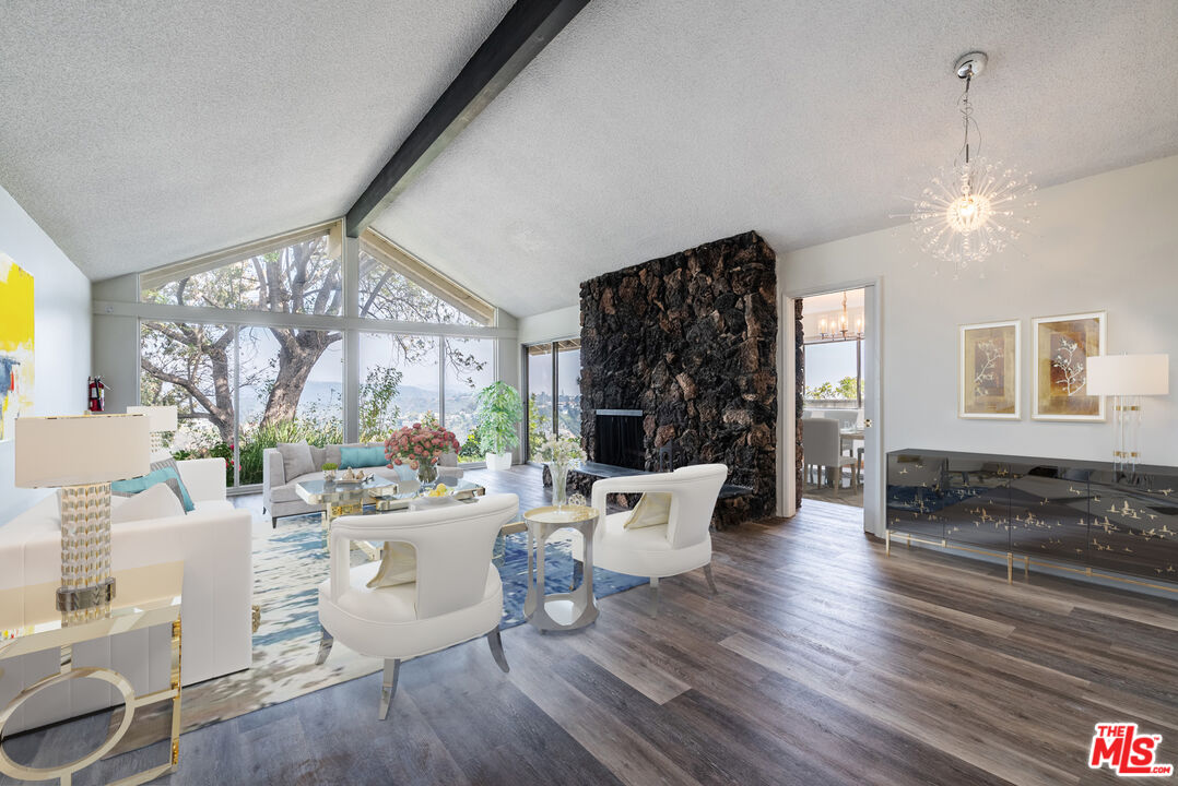 1342 Stradella Road Los Angeles, CA 90077 - Photo 4 of 24 a living room with furniture a window and a chandelier