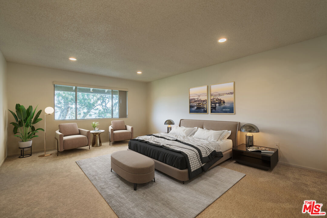 1342 Stradella Road Los Angeles, CA 90077 - Photo 9 of 24 a spacious bedroom with a bed and a couch