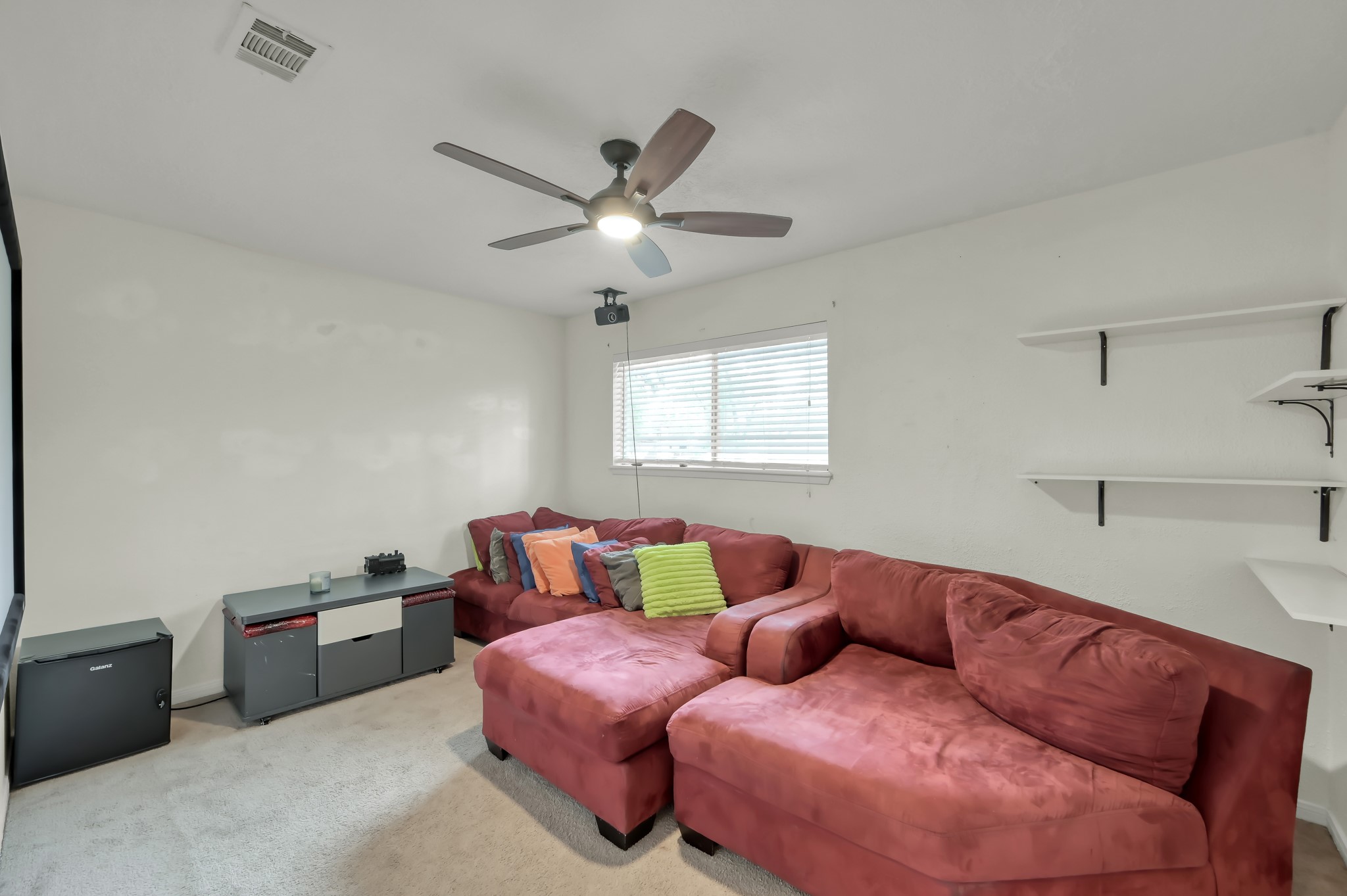 25610 Walnut Grove Circle Spring, TX 77380 - Photo 22 of 29 a bedroom with a bed and a chandelier