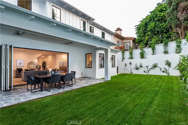 a view of a house and a yard with table and chairs
