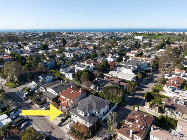 an aerial view of residential houses with swimming pool and outdoor space