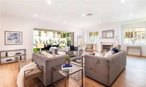 a living room with fireplace furniture and a large window