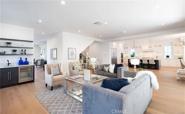 a living room with furniture and a dining table with kitchen view