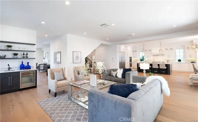 a living room with furniture and a dining table with kitchen view